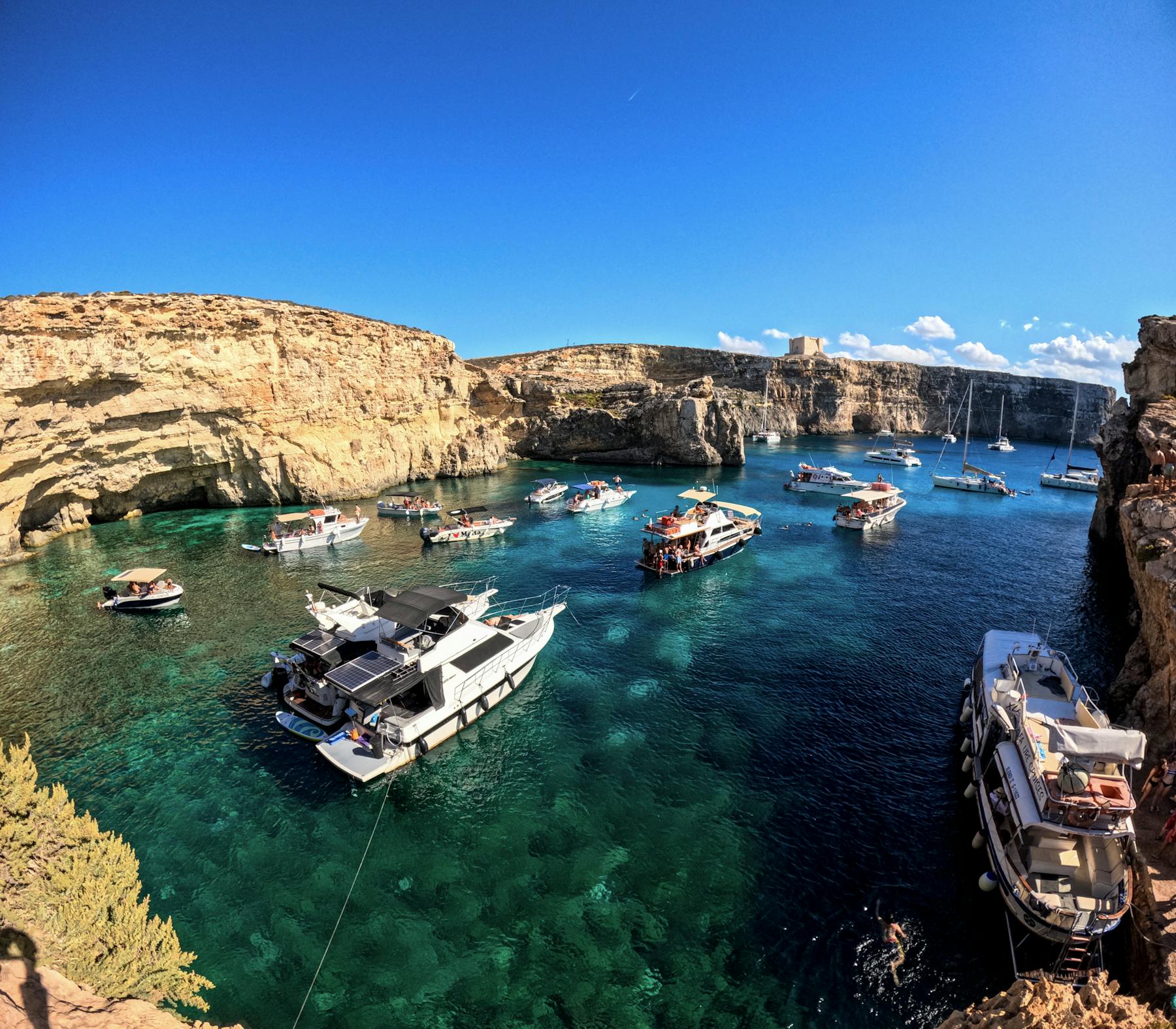 Blue Lagoon in Malta with boats and clear Mediterranean water
